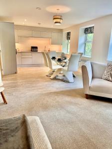a large living room with a table and chairs at York House luxury 2 bedroom apartment in Ashby de la Zouch
