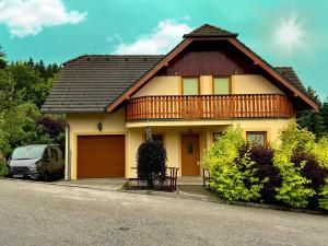 a house with a wooden roof and a car parked in front at Villa Slupečná in Lipno nad Vltavou