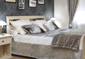 a bedroom with a bed with pillows on it at Villa Marguerite in Coutras +20 photos