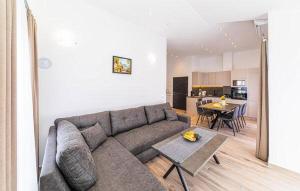 a living room with a couch and a table at Apartmani Kornelija in Kaštela