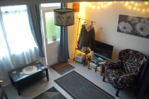 a living room with a chair and a window at Dawlish Warren Welcome family holiday park South Devon Willow villa Welcome2Warren in Dawlish Warren
