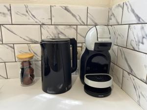 a coffeemaker and a coffee maker on a counter at Eretria Lofts in Eretria