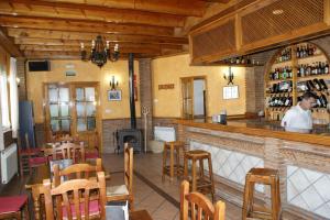 a man standing at a bar in a restaurant at Hotel Juan Francisco in Güéjar-Sierra