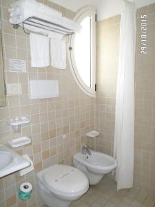 a bathroom with a toilet and a sink at Hotel Houston in Rimini