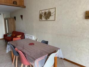 a dining room with a wooden table and chairs at Ch'ti NID au pays des lacs in Alièze +20 photos