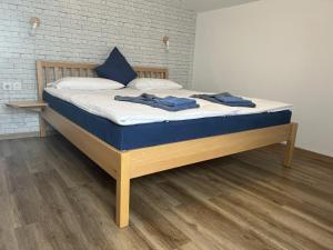 a bed with blue towels on it in a room at Penzion TTT in Bled +45 photos