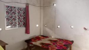 a room with a table with flowers on it at RRc 11 in Katihār