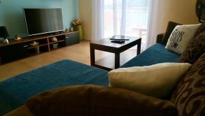 a living room with a couch and a tv at Apartment Leonora in Vinišće