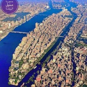 an aerial view of a city and a river at شقق المنيل in Cairo