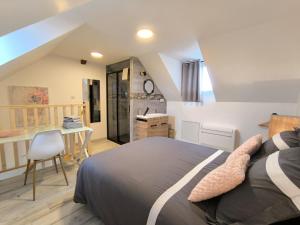 ein Schlafzimmer mit einem Bett und einem Schreibtisch mit Stuhl in der Unterkunft Gite Bonheur et Charme Spa-Sauna forfait 2h inclus in Kintzheim