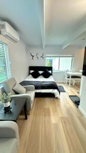 a bedroom with a bed and a couch and a table at Modern Studio Stylish &Cozy Back Unit in Los Angeles