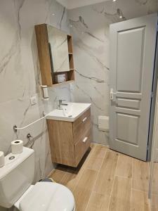 a bathroom with a toilet and a sink at L'Escale in Bonifacio