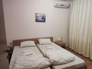 a bedroom with two beds with white sheets at Sea view apartment in paradise in Elenite +16 photos