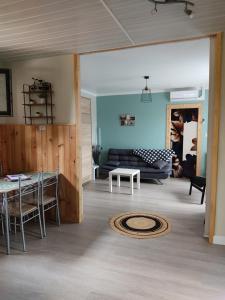 a living room with a couch and a table at Le champenois in Lanobre