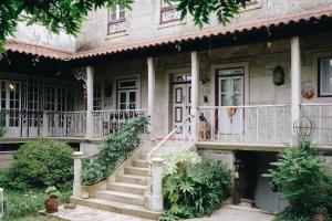 an old house with stairs in front of it at Casa d'Aldeia de Souto de Lafões OLIVEIRA DE FRADES in Oliveira de Frades