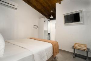 Cama o camas de una habitación en Bossa Jurerê Hotel