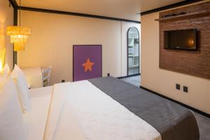 Cama o camas de una habitación en Bossa Jurerê Hotel