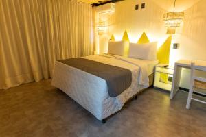 Cama o camas de una habitación en Bossa Jurerê Hotel