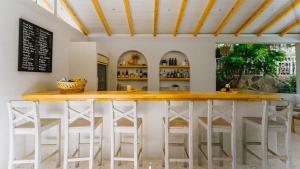a kitchen with a bar with stools around it at Golden Lighthouse Hotel in Patara