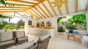 an outdoor living room with chairs and a bar at Golden Lighthouse Hotel in Patara