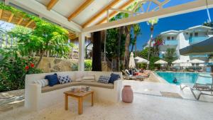 a living room with a couch and a table and a pool at Golden Lighthouse Hotel in Patara