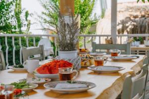 a wooden table with plates of food on it at Golden Lighthouse Hotel in Patara
