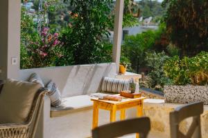 a patio with a couch and a table and a window at Golden Lighthouse Hotel in Patara