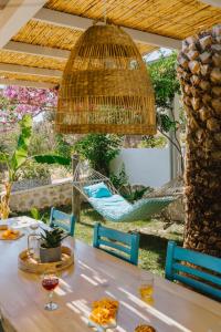 a patio with a table and chairs and a hammock at Golden Lighthouse Hotel in Patara