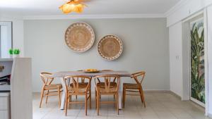 a dining room table with chairs and plates on the wall at Golden Lighthouse Hotel in Patara