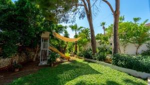 a yard with a swing and trees and a fence at Golden Lighthouse Hotel in Patara