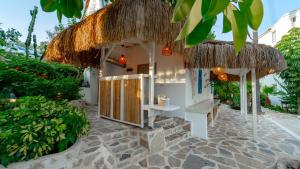 a small building with a straw roof at Golden Lighthouse Hotel in Patara