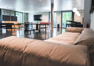 a living room with a couch and a table at Hotel am Campus in Mönchengladbach