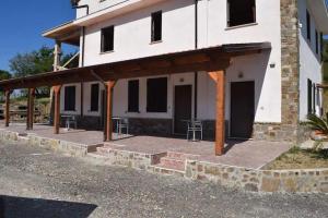 a building with a porch with tables and chairs at Villa Sandro in Agropoli