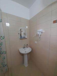 a bathroom with a white sink and a shower at Sofia's Rooms in Himare +48 photos