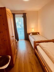 A bed or beds in a room at Ciasa Fam Comploi