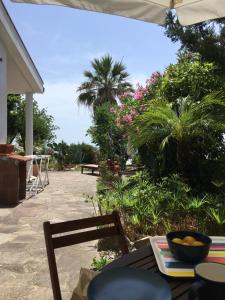 a patio with a table and chairs and plants at Il Pettirosso in Acciaroli +37 photos