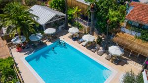 an overhead view of a swimming pool with umbrellas at Golden Lighthouse Hotel in Patara