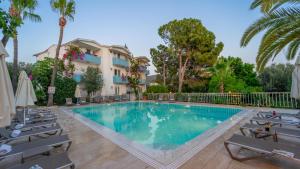 a swimming pool in front of a hotel at Golden Lighthouse Hotel in Patara