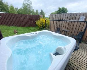 a jacuzzi tub in a backyard at Kaoglen Warren - Pet friendly - Hot Tub - Cairngorms in Blairgowrie