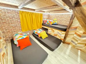 a room with two beds in a brick wall at New open Hotel Jungle fun fun J4 USJ 8minutes nishikujyo 3minutes in Osaka