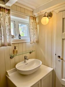 a bathroom with a sink and a window at Veslegarden in Lærdalsøyri +22 photos