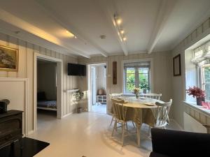 a dining room with a table and chairs and a bedroom at Veslegarden in Lærdalsøyri