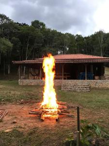 a large fire in front of a house at Vila Dravida Petar in Iporanga