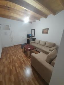 a living room with a couch and a table at Sofia's Rooms in Himare