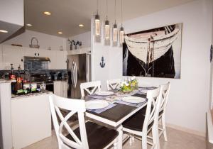 a kitchen with a dining room table and chairs at InHomeStays in Lakewood +38 photos