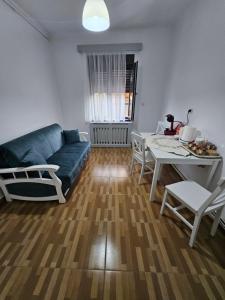 a living room with a blue couch and a table at Casa Raduly in Sibiu