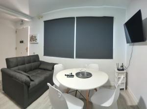 a living room with a couch and a table at Warner Dreams in San Martín de la Vega