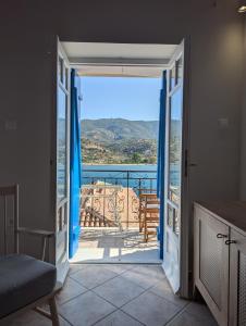 a door leading to a balcony with a view at Thama Poros in Poros +13 photos