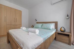 een slaapkamer met een bed met handdoeken erop bij Andreas Rodos Apartment in Rhodos-stad