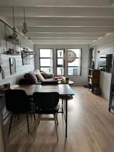 a living room with a dining room table and chairs at Voss Hytte/Cabin in Skulestadmo